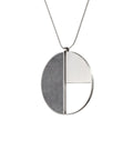 The Elements Nagy necklace by KONZUK captures the avant-garde spirit of László Moholy-Nagy's Bauhaus influence through concrete and stainless steel materials, blending art with technology.