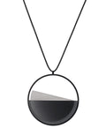 The Clara necklace in ash grey embodies clarity and balance. Named from the Latin clarus, meaning “bright” or “clear,” it reflects the quiet harmony of light and material. Within the circular frame, concrete emerges from the surface of the resin, creating a gentle rise in tone and texture. The Clara necklace carries a calm, sculptural presence that feels both modern and enduring.