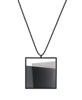 Derived from the Latin  mare, meaning “sea,” the Mara necklace in ash grey evokes depth, stillness, and movement within form. Concrete is cast into resin inside a square frame, where the materials meet in a smooth, fluid line. The surface reflects light with quiet subtlety, creating the sense of horizon and depth. The Mara necklace embodies balance and serenity through modern, sculptural design.
