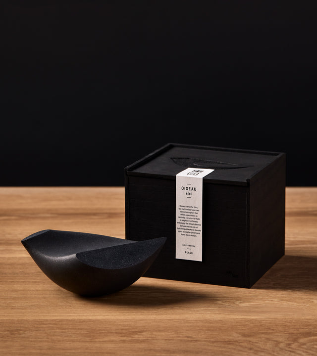 Black small (Bébé) Oiseau sits next to custom box gift packaging.