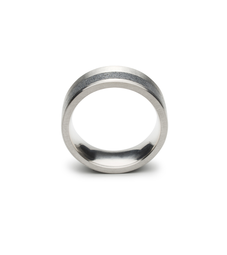 Concrete set into architecturally inspired stainless steel bands. View from the front.