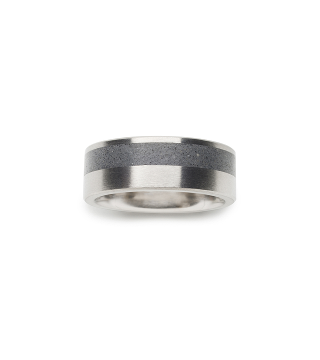 Minimalist concrete ring designed off-set between stainless steel bands. Top view of concrete ring.