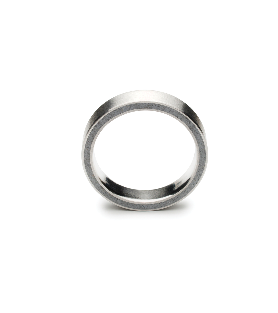 Front profile of a stainless steel ring designed with concrete cast into the side.