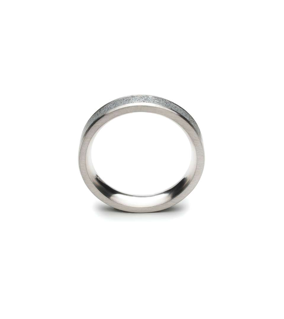 Front profile of small concrete and stainless steel ring.