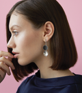Bauhaus inspired Freya earrings feature two double stainless steel domes, one lined with diamond dust infused black concrete both architecturally supported an elegant hanging steel post.