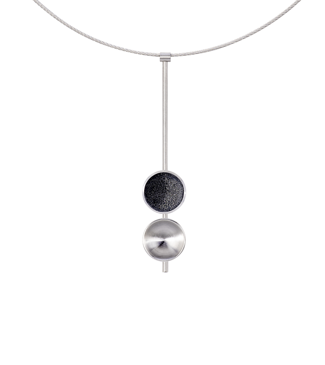 The Freya Minor modern necklace features two double stainless steel domes, one lined with diamond dust infused black concrete both architecturally supported an elegant hanging steel post.