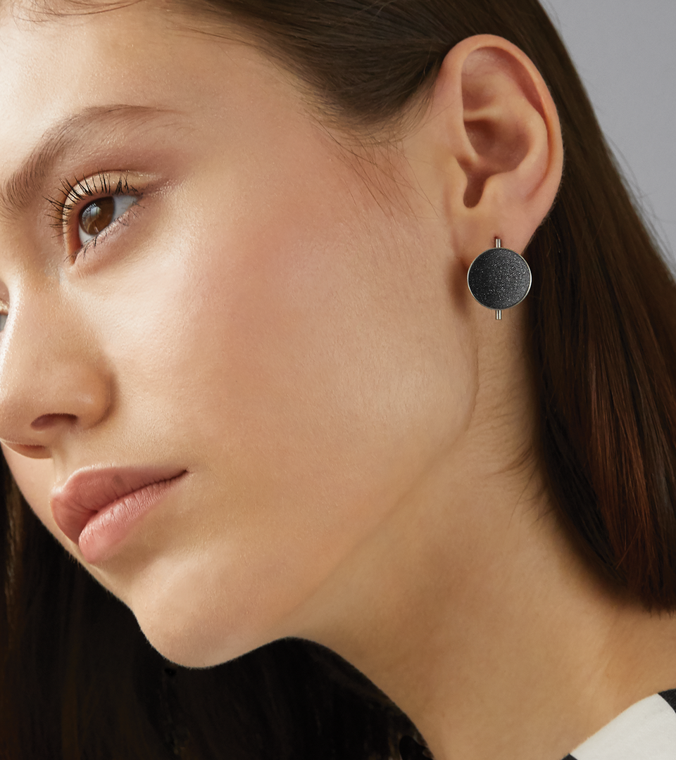 Bauhaus inspired Juno earrings sparkle with diamond dust and black concrete lined stainless steel dome a minimalist steel post. 