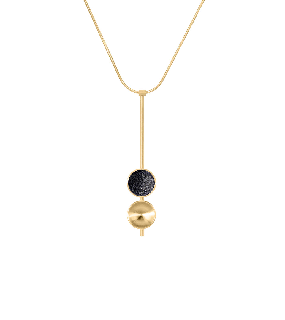 The Freya Minor modern necklace features two double solid 14 karat gold domes, one lined with diamond dust infused black concrete both architecturally supported an elegant hanging 14k gold post.