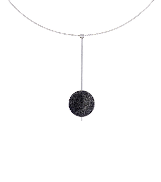 The Inspira necklace feature authentic diamond dust embedded into a concrete lined stainless steel dome architecturally positioned onto a suspended minimalist steel post. 
