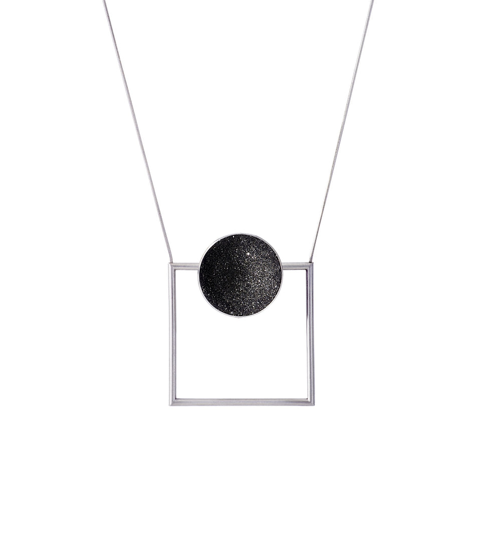 Contemporary necklace combines the geometry of a smaller stainless steel dome lined with the sparkle of diamond dust encrusted concrete suspended onto a minimalist steel square frame.