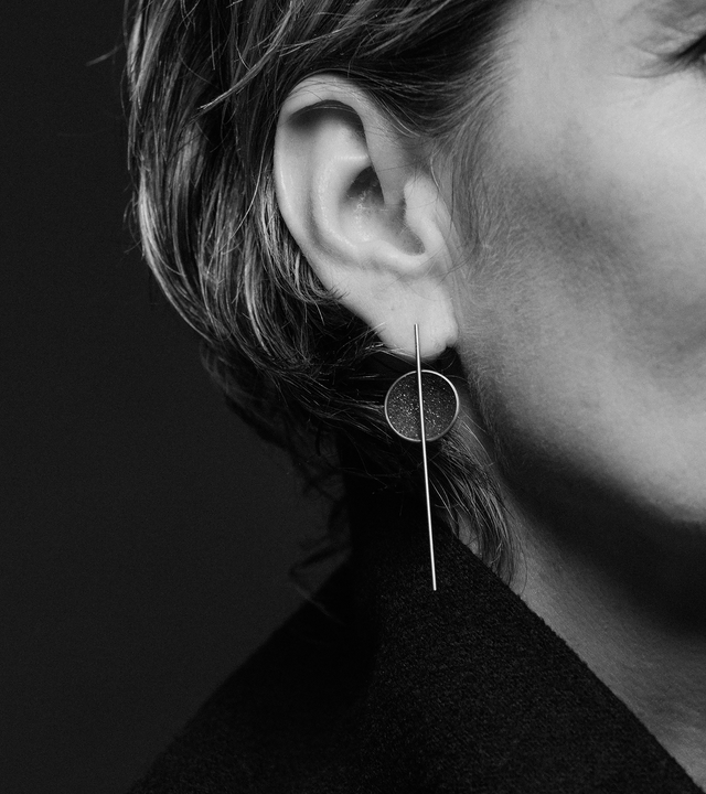 Infini earrings are designed with Diamond dust infused concrete lined stainless steel dome intersected by the bauhaus like detail of a minimalist steel post.
