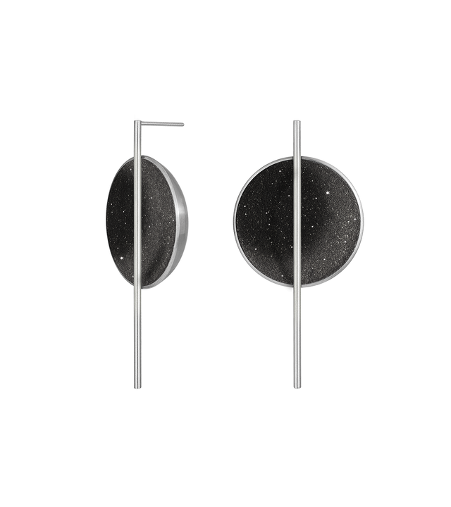 The Linnea Major statement earrings sparkle with diamond dust and black concrete set into a stainless steel dome architecturally suspended behind a minimalist steel post. 