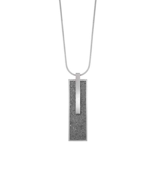 Memento Beholden locket with concrete set into rectangular stainless steel framework.