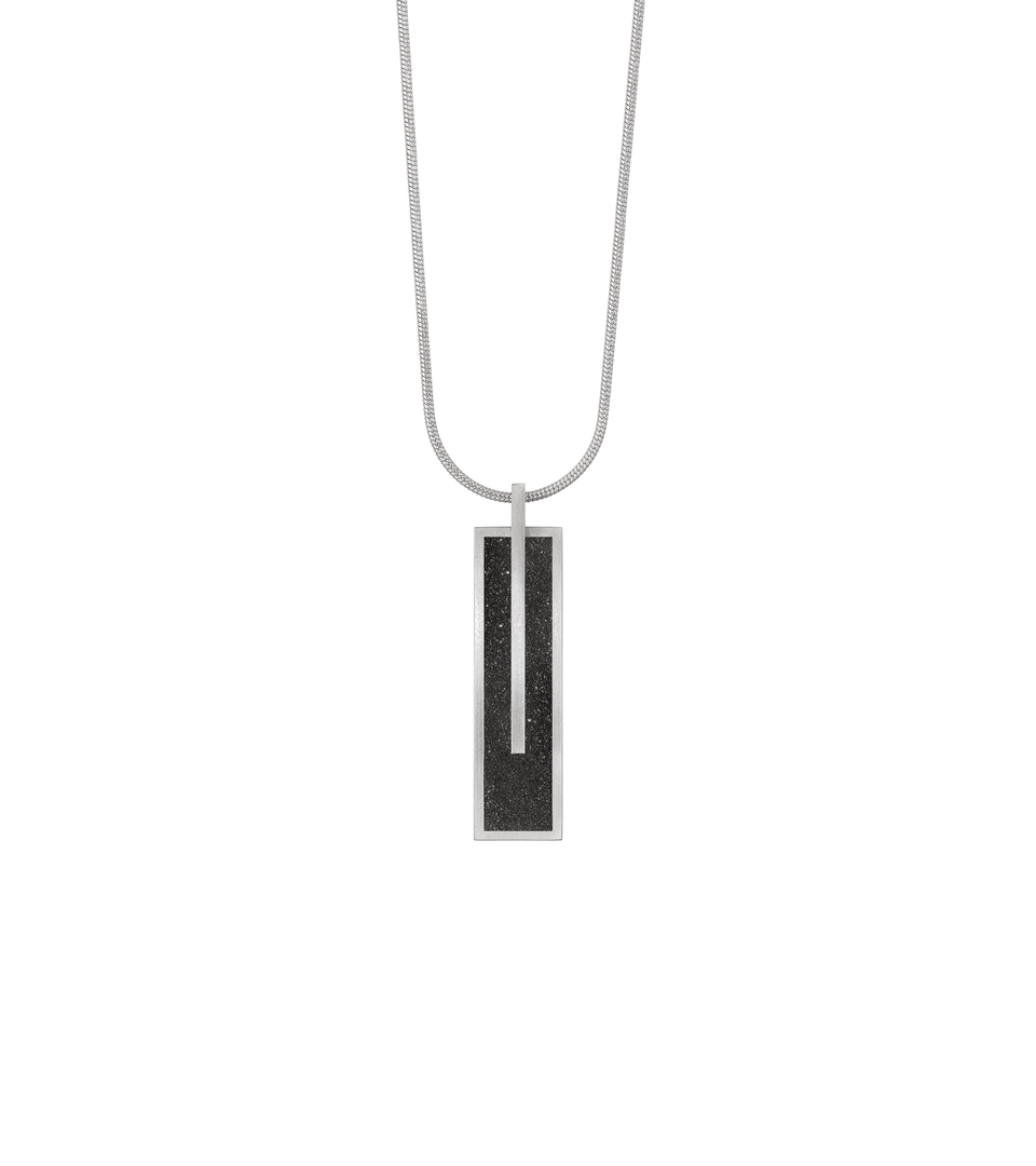 Memento Beholden pendent with diamond dust encrusted concrete set into small rectangular stainless steel design.