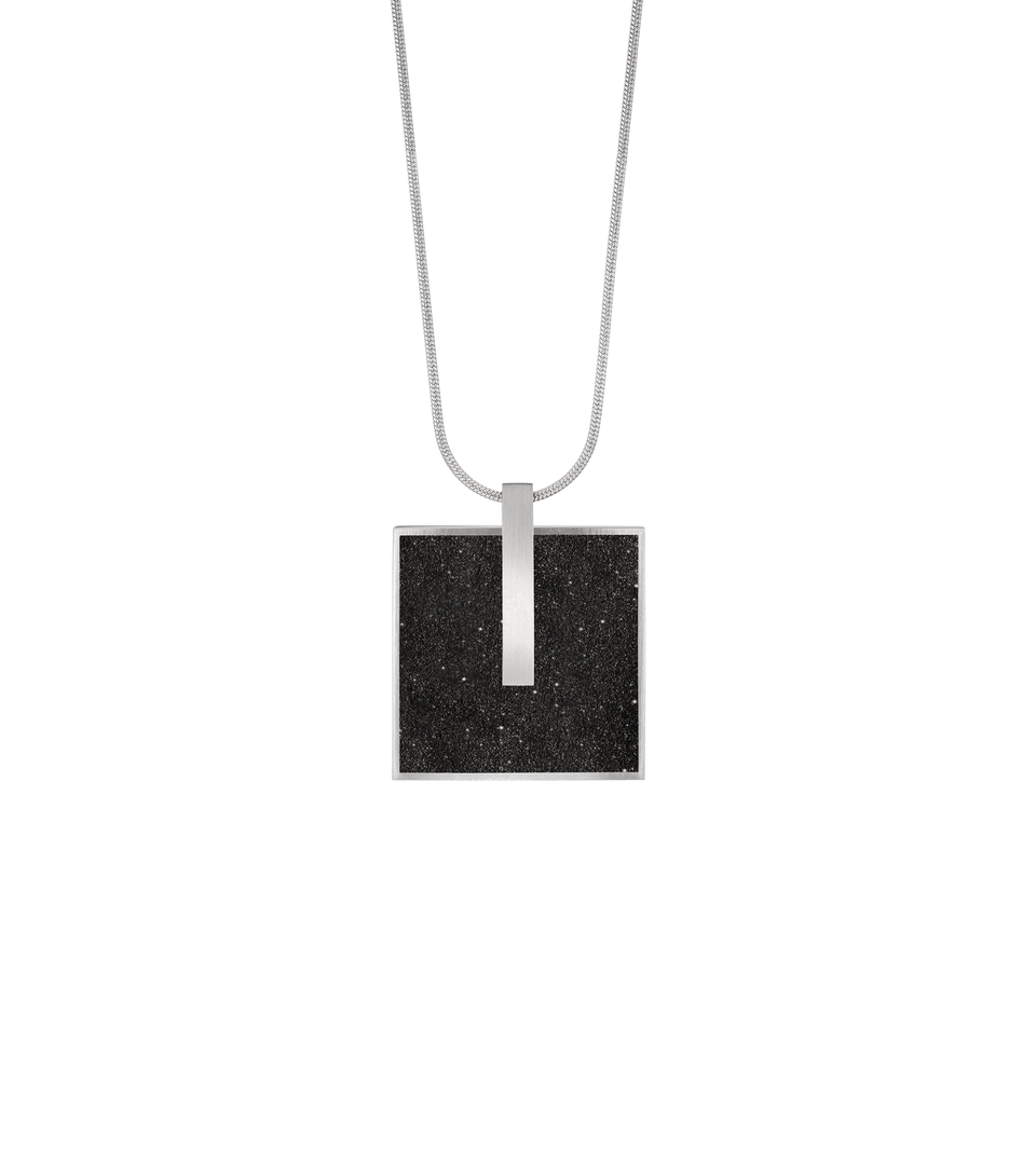 Concrete-and-diamond dust set square stainless steel locket necklace hangs from a stainless snake chain.