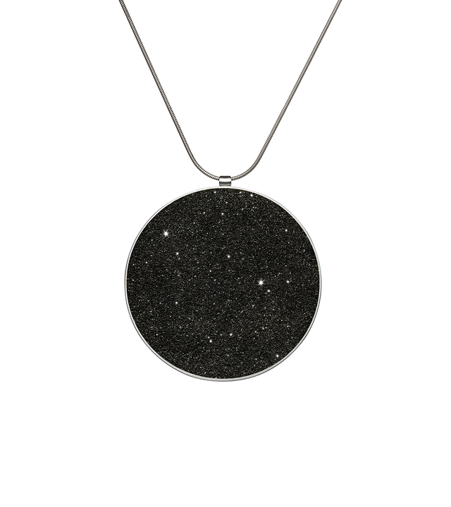 Maia Major concrete necklace set with diamond dust inside a minimalist stainless steel geometric form hanging centred from an elegant chain.