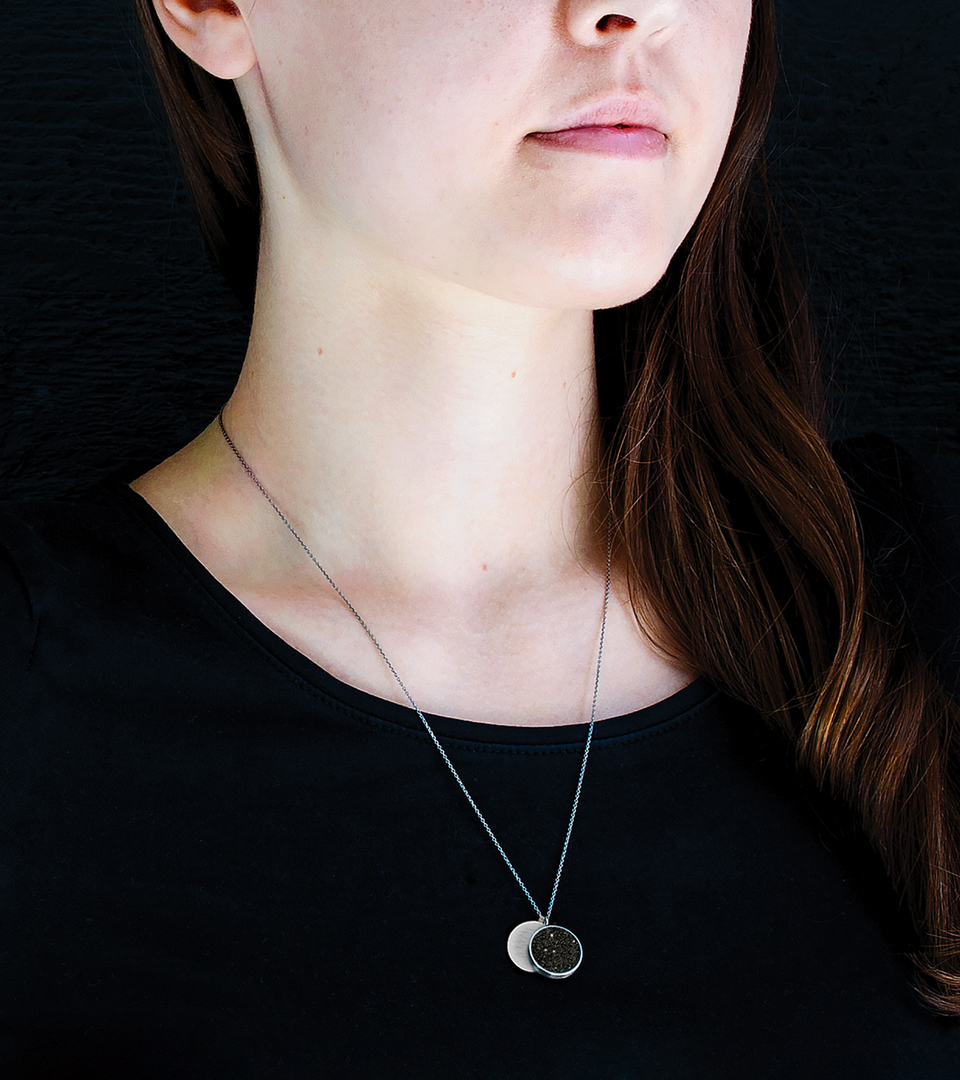 Round stainless steel necklace set with concrete-and-diamond dust.