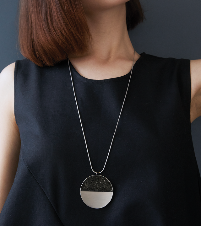 Mira Major concrete and diamond dust necklace achieves minimalist beauty with modernist jewelry design that echoes architectural principles of balance, rhythm and harmony.