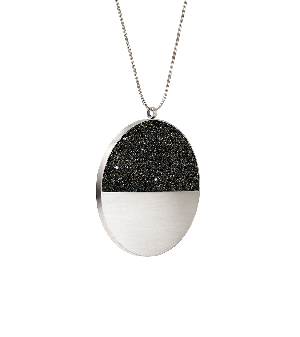The statement sized Mira Major concrete and diamond dust necklace achieves minimalist beauty with modernist jewelry design that echoes architectural principles of balance, rhythm and harmony.